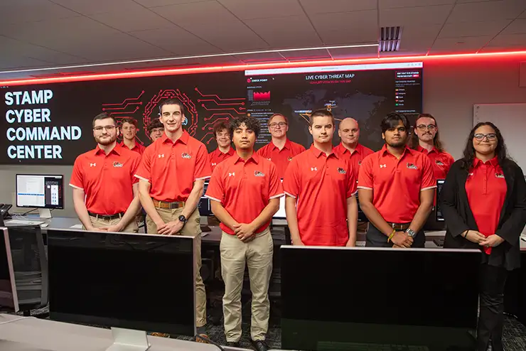 SEMO's cyber defense team in the charles stamp cyber command center, wearing semo polo shirts.